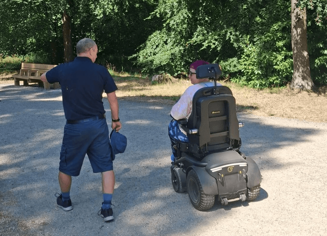 Attendee trialling Freedom powerchair with SDL staff