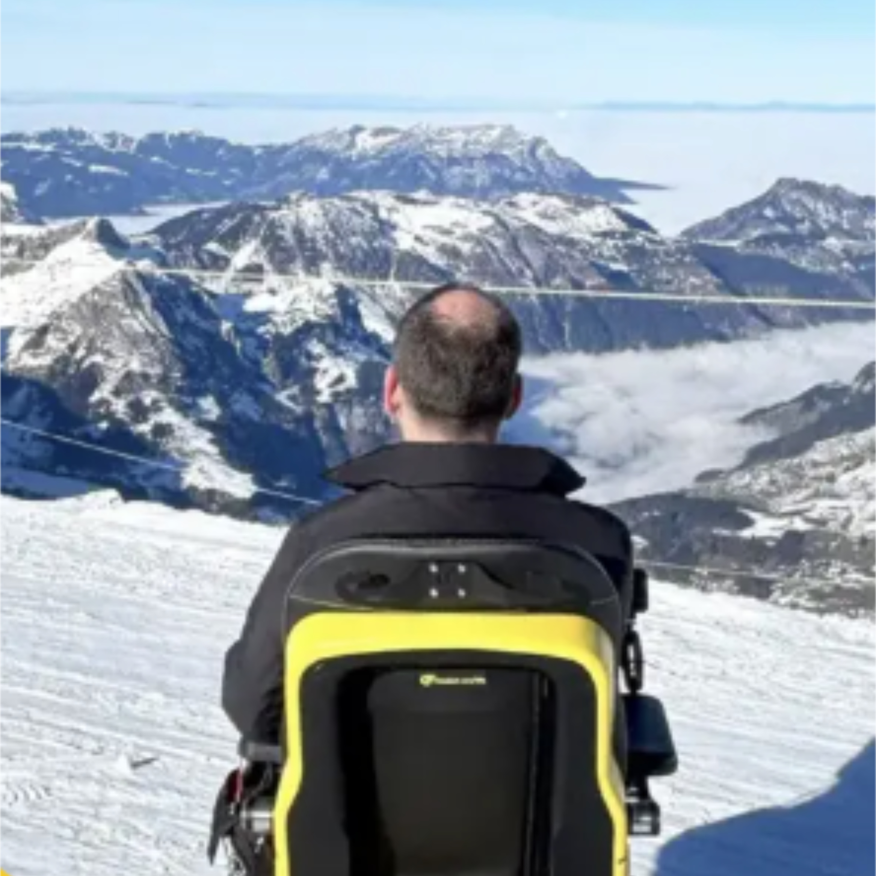 Series 5 powerchair user looking out over snowy mountains