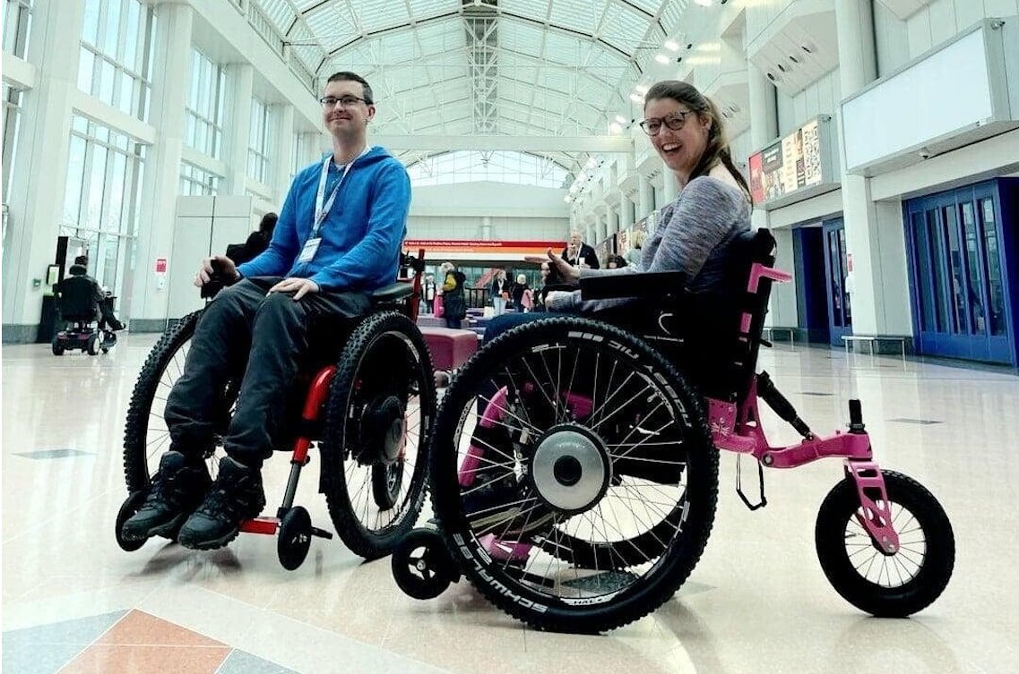 Two SD Motion users smiling at an indoor venue